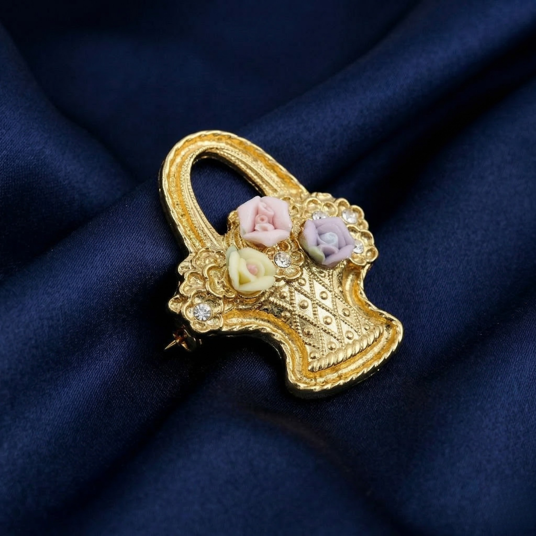 Decorative brooch with floral porcelain rose design on a blue fabric background