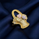 Decorative brooch with floral porcelain rose design on a blue fabric background
