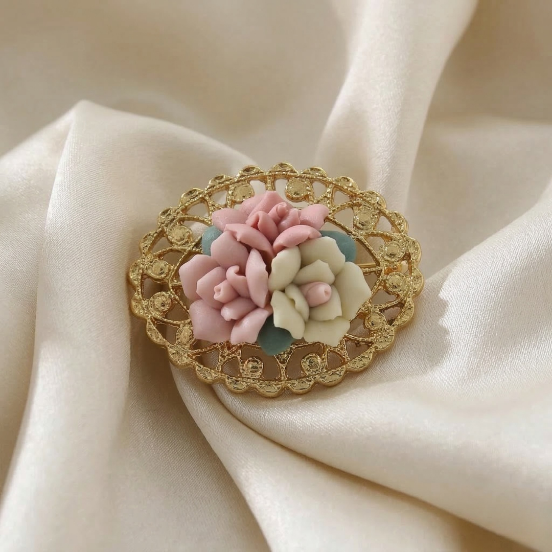 Decorative brooch with floral, multicolor porcelain rose design on a beige fabric background