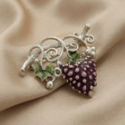 Winery Purple Grapes On Vine Pin displayed on draped beige fabric.