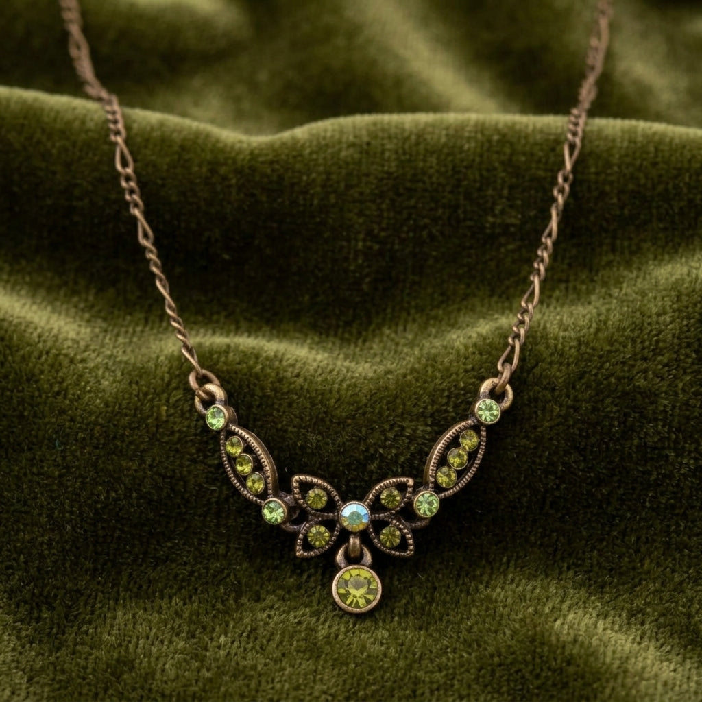 Necklace with green crystals on a green fabric background