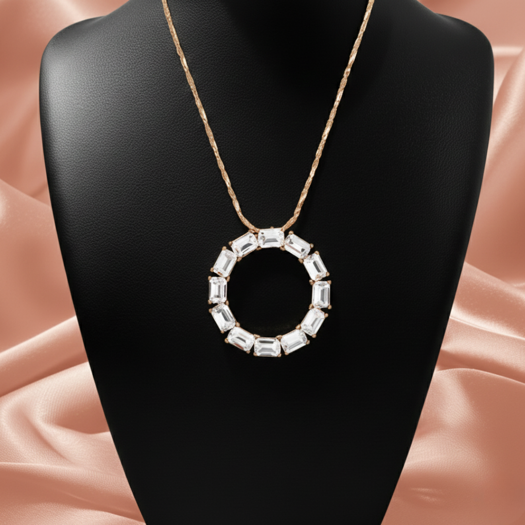 Crystal necklace with a gold tone chain on a black necklace display. 