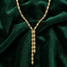 Gold Fancy Link Chain Drop Necklace on a green velvet background