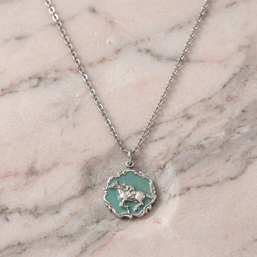Turquoise Color Enamel Horse Pendant Necklace on a marble surface