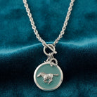 Turquoise Color Enamel Horse Pendant Toggle Necklace on teal fabric
