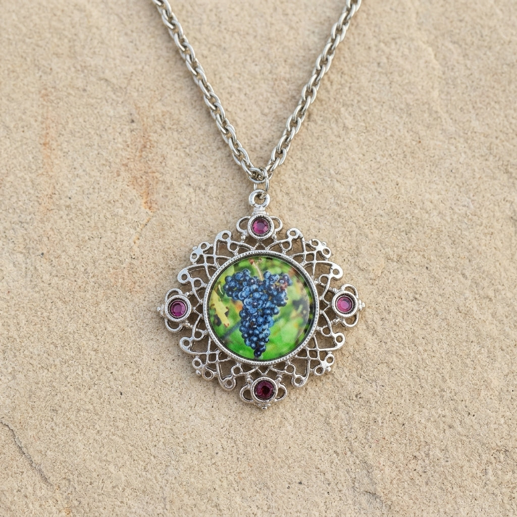 Winery Purple Grapes Decal And Filigree Pendant Necklace 16" + 3" Extender displayed on a textured beige stone surface.