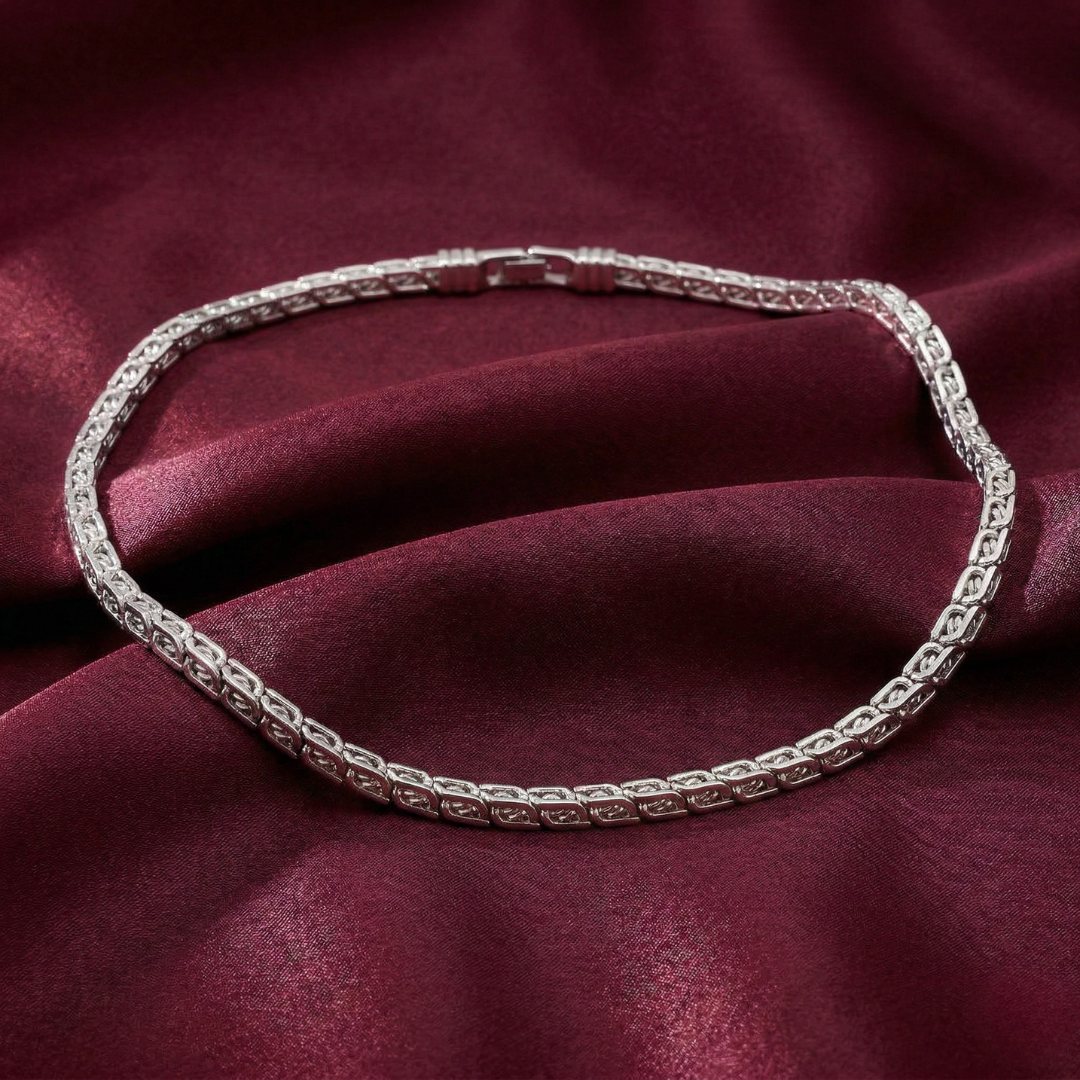 Silver necklace on a burgundy fabric background