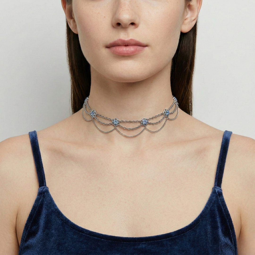 Woman wearing a delicate choker necklace with a plain background
