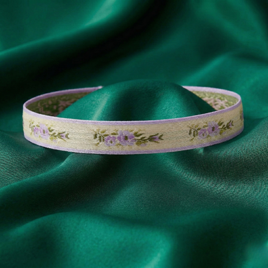 Decorative choker necklace with floral pattern on a green fabric background