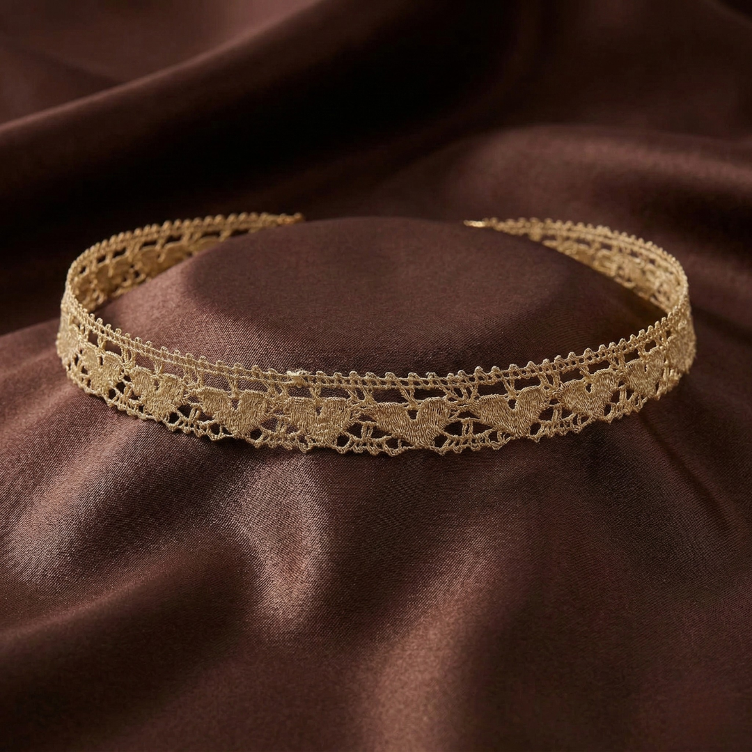 Ivory lace headband on a brown fabric background