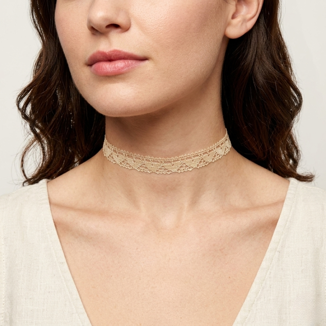 Woman wearing a delicate ivory lace choker necklace against a neutral background