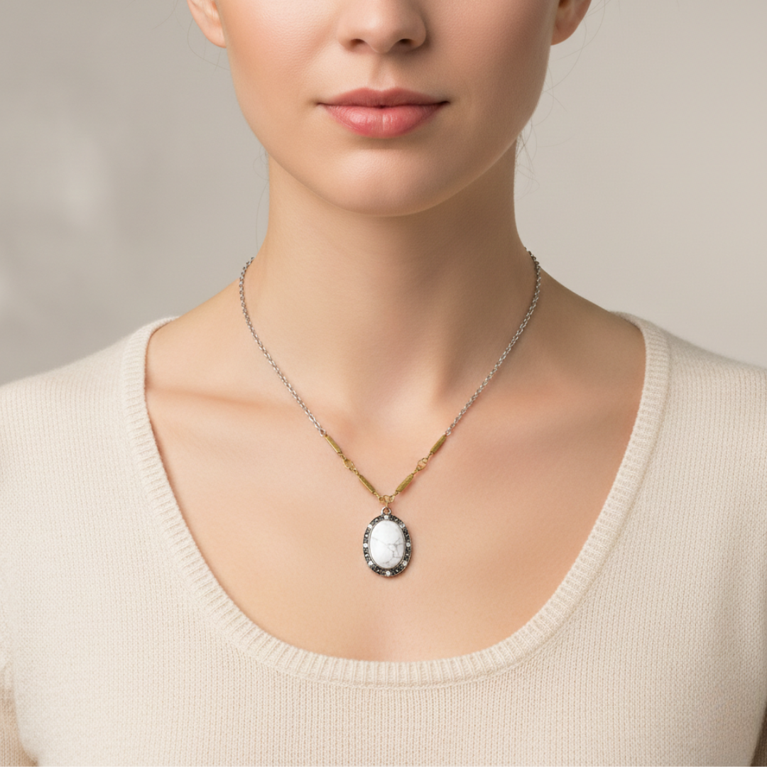 Necklace with a pendant worn by a person against a neutral background