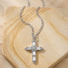 Large Silver Tone Crystal Cross Pendant Necklace on a stone surface