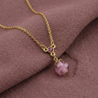 Light Amethyst Quartz Glass Round Bead Crystal Accent Drop Pendant Necklace on a dark purple fabric background