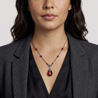 Woman wearing a Siam Red Teardrop Pendant Necklace with AB crystals.