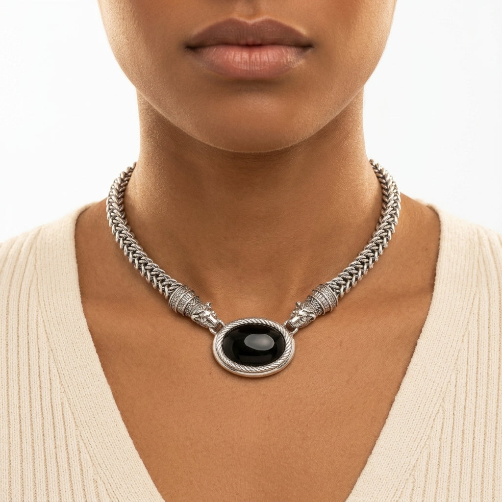 Antiquities Couture Jaguar Black Onyx Stone Symmetry Necklace worn by a woman with a white top and a neutral background