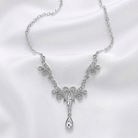 Silver necklace with a decorative clear crystals and a pendant on a white background