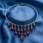 Necklace with purple beads on a blue satin background