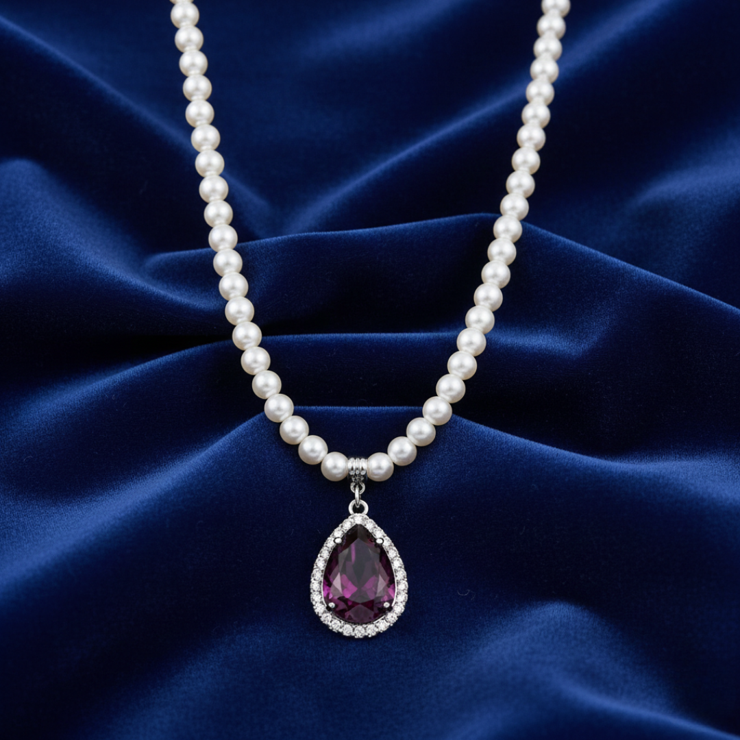 Pearl necklace with a purple teardrop pendant on a blue satin background