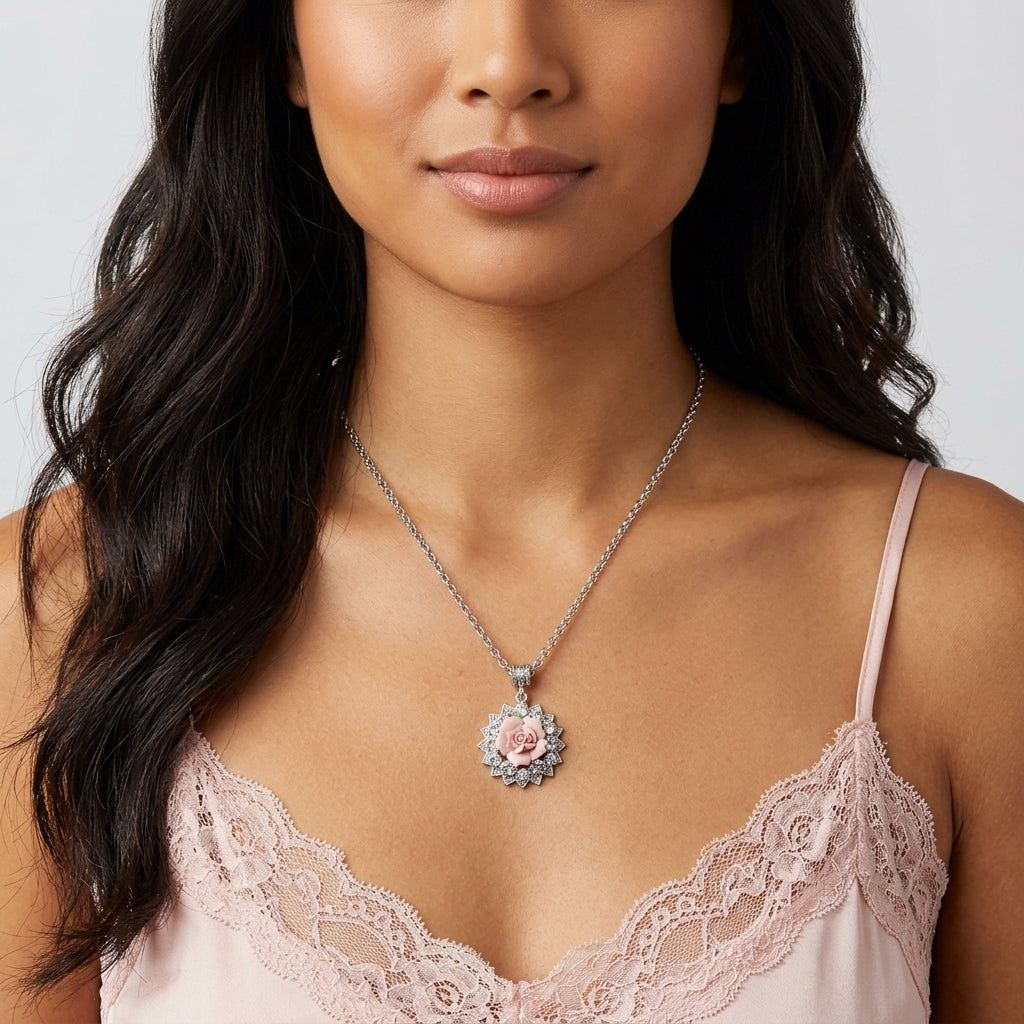 Woman wearing a necklace with a floral porcelain rose pendant against a neutral background