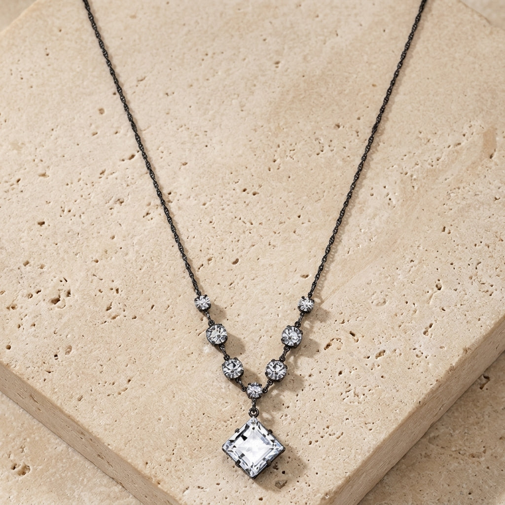 Genuine Austrian Crystal Diamond Shape Pendant Necklace 16" + 3" Extender resting on limestone