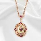 Rose gold necklace with floral pendant on a white background.