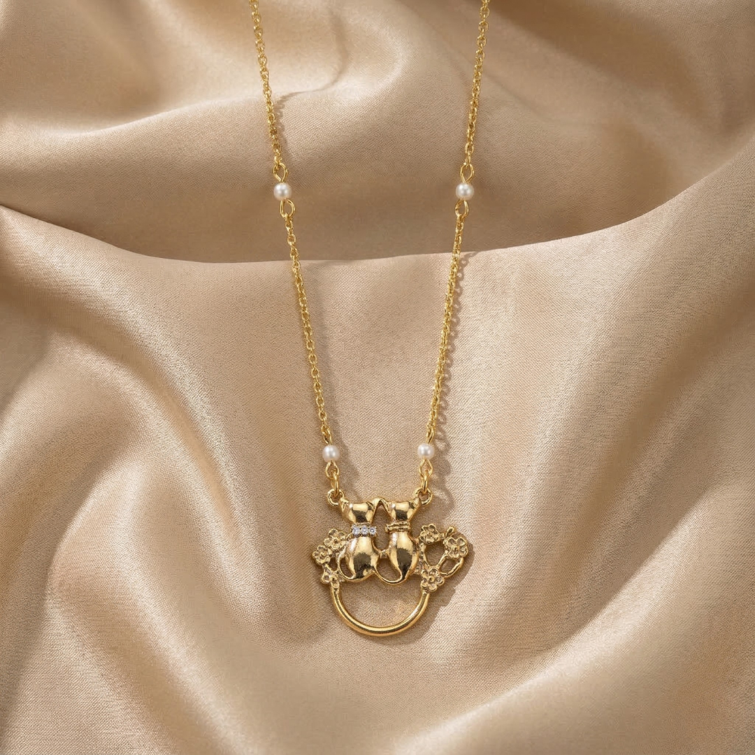 Gold necklace eye glass holder with a decorative pendant on a beige fabric background