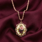 Necklace with a floral pendant on a maroon fabric background