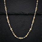 Antiquities Couture Faux Pearl And Crystal Rope Necklace resting on black stone