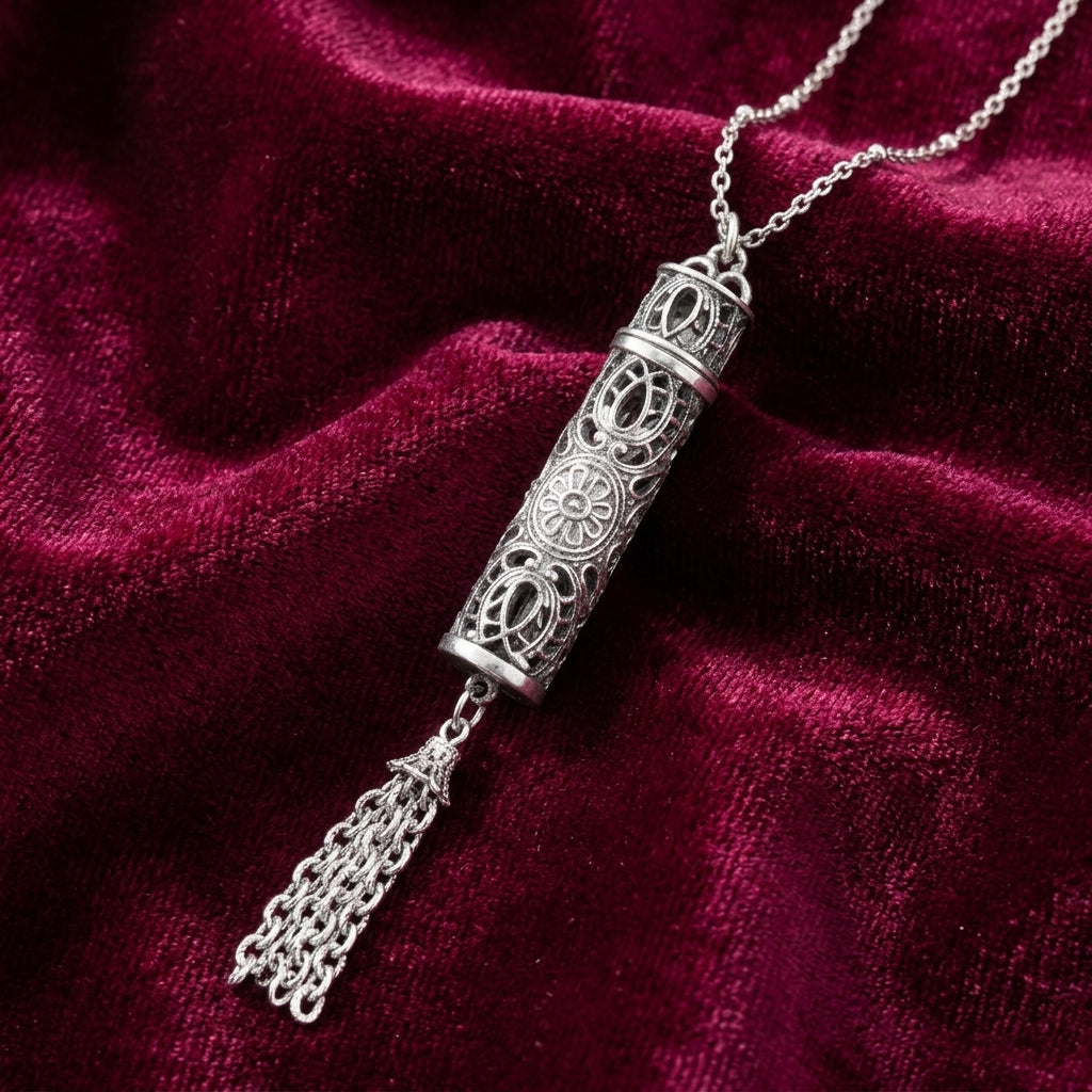 Silver necklace with intricate vial design pendant on a red velvet background