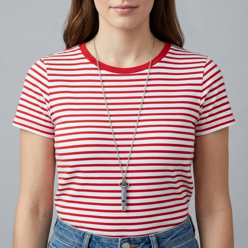 Person wearing a red and white striped shirt with a blue pave crystal whistle pendant necklace