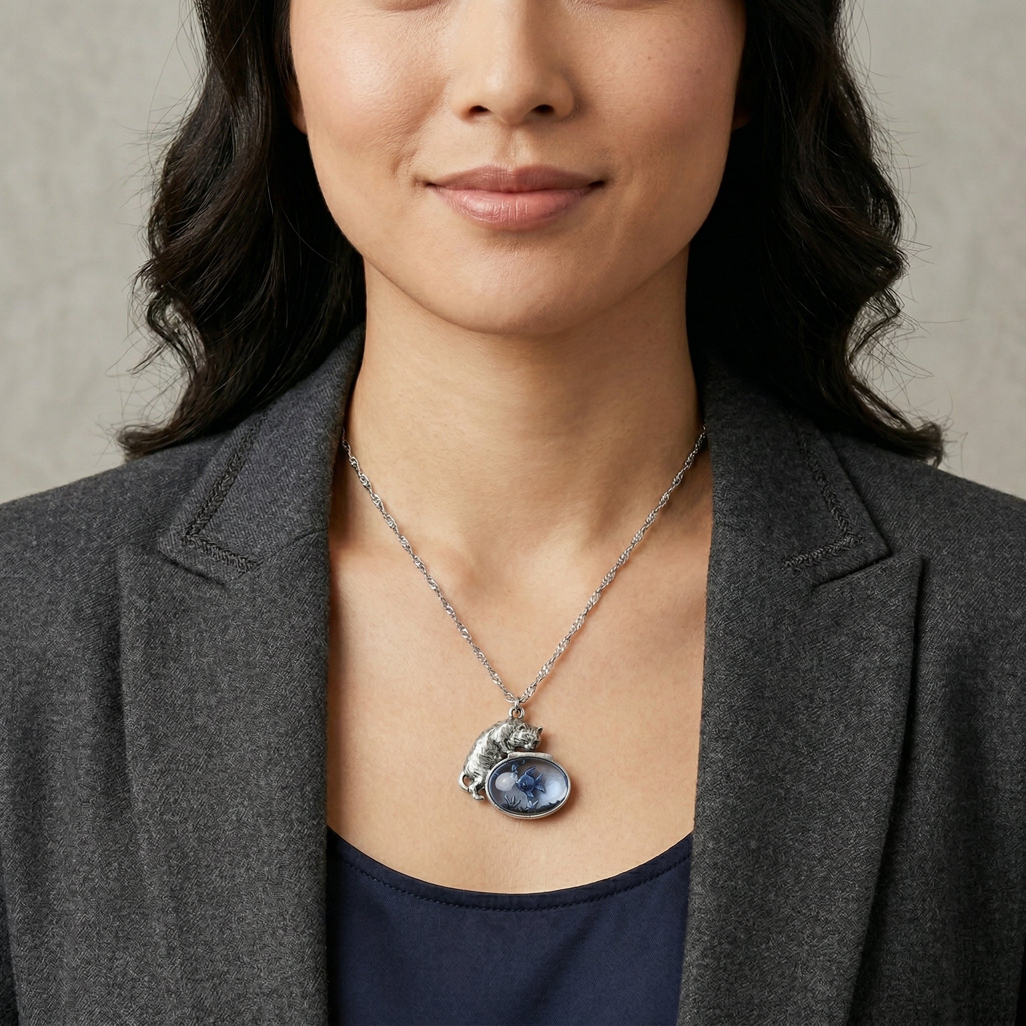Woman wearing a Whimsical Cat & Blue Fish Pendant Necklace with a dark blazer