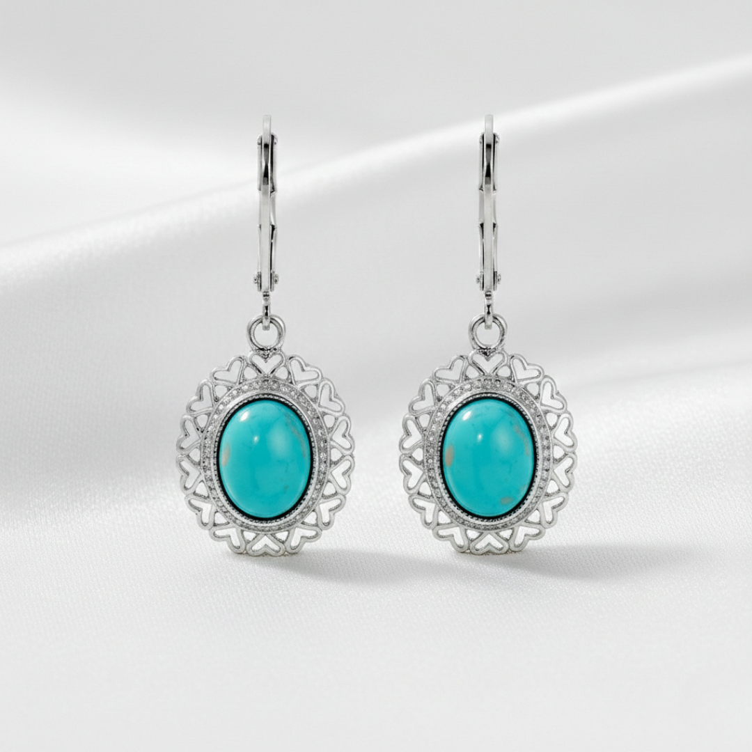 Turquoise earrings with silver filigree on a white background