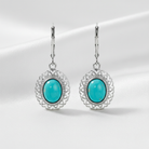 Turquoise earrings with silver filigree on a white background