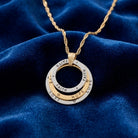 Faith, Hope, Love Trinity Rings Pendant Necklace on a blue fabric background