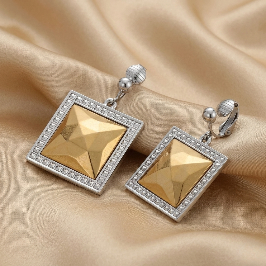 Fusion lux square earrings with silver accents on a beige fabric background