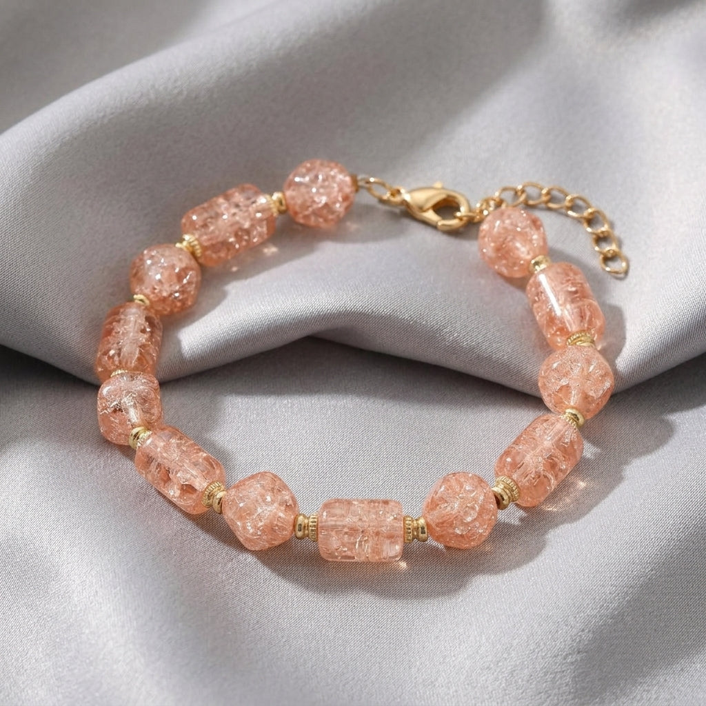 Beaded Peach Cracked Glass Bracelet resting on gray fabric