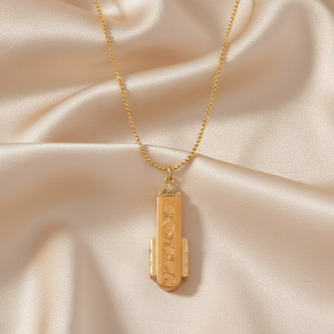 Gold necklace with a pendant on a beige fabric background