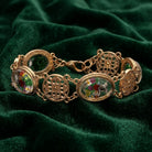 Gold tone Meso Round Intricate Filigree & Mixed Flower Bouquet German Glass Link Bracelet on green fabric