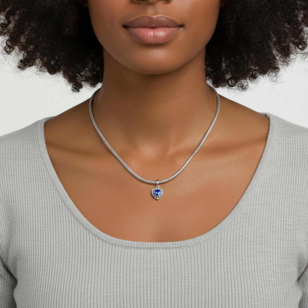 Woman wearing a silver necklace with a heart-shaped pendant