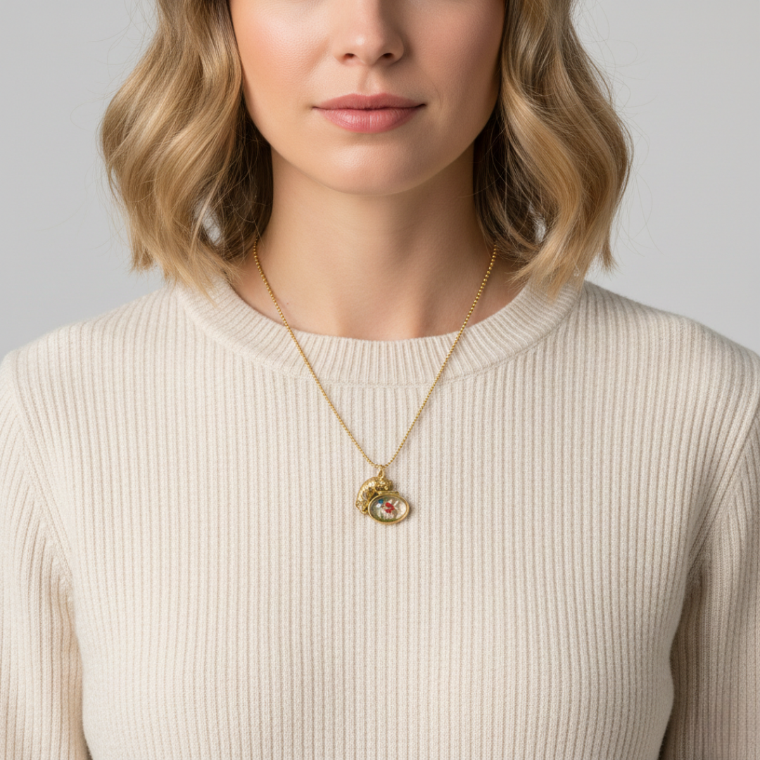 Woman wearing a gold necklace with a pendant against a neutral background