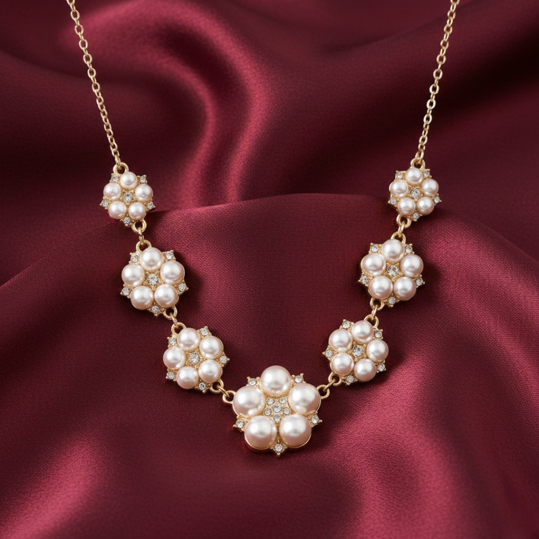 Faux pearl necklace on a burgundy satin background