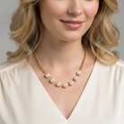 Woman wearing a faux pearl necklace against a neutral background