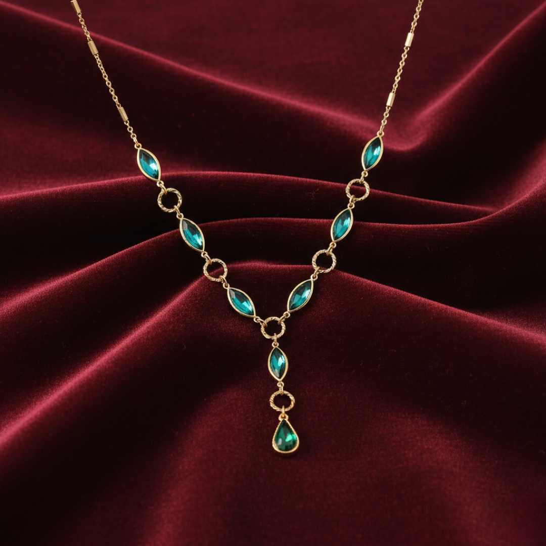 Gold necklace with turquoise stones on a red velvet background