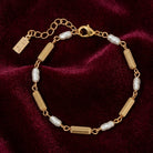 Gold bracelet with pearls on a burgundy velvet background