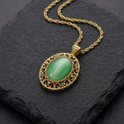 Gold necklace with a green pendant on a dark stone surface