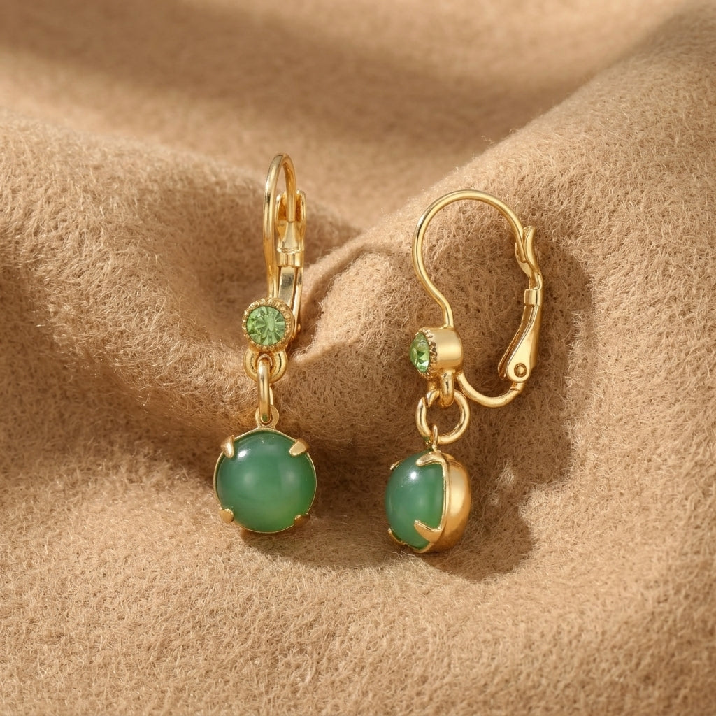 Peridot Crystal & Round Green Moonstone Drop Earrings resting on tan colored felt