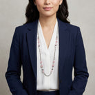 Woman wearing a navy blazer and white blouse with a Roseate Paradise Peppermint Pink Rose Austrian Crystal Beaded Necklace