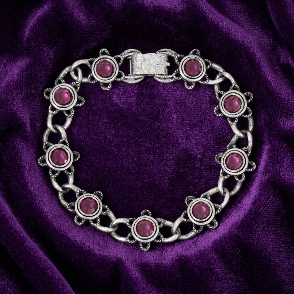 Silver bracelet with amethyst gemstones on a purple velvet background