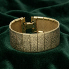 Gold Floral Bracelet on dark green fabric